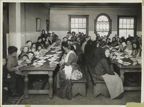 Uncle Sam, host. Immigrants being served a free meal at Ellis Island, 1902, Flickr