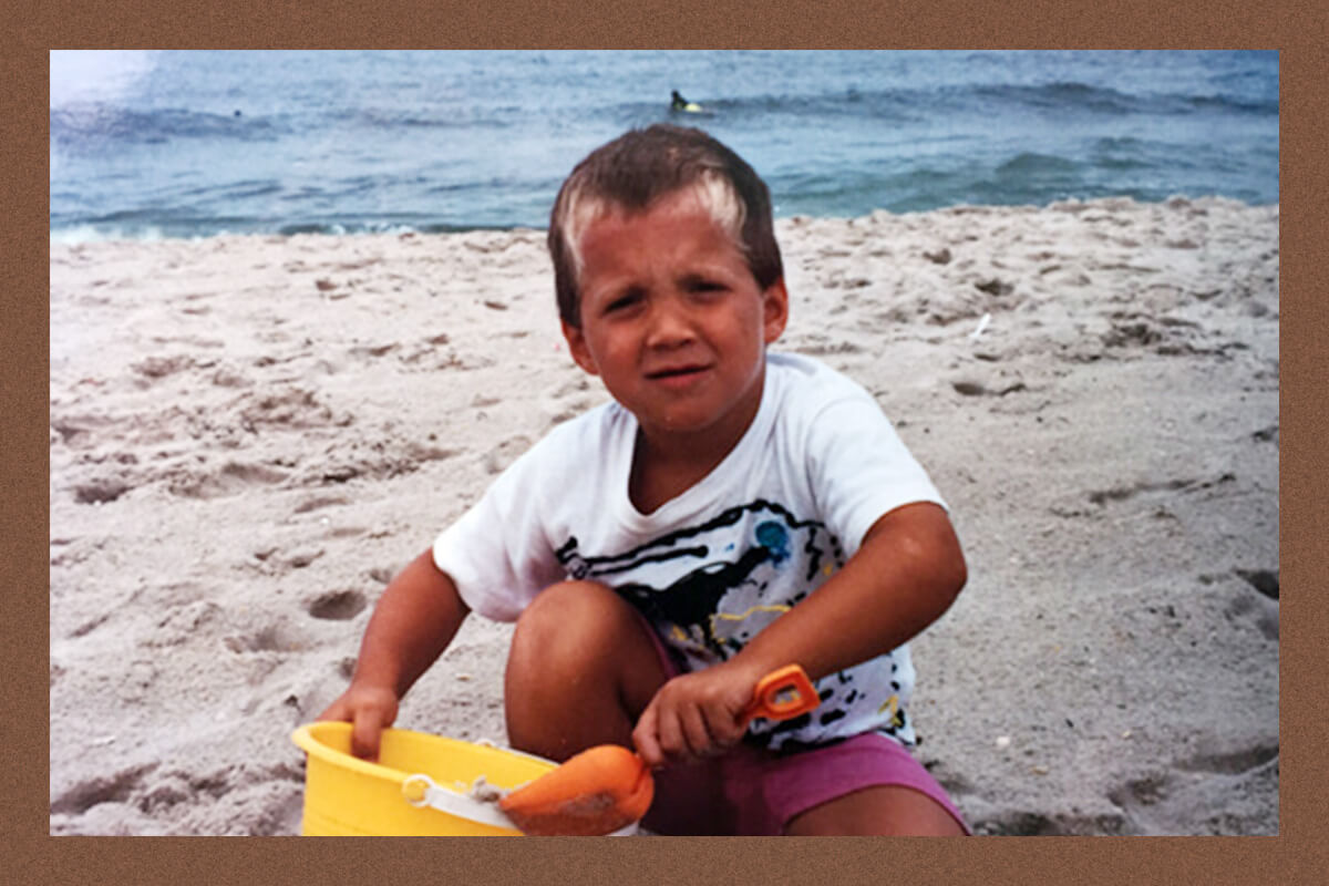 The author as a child playing at the beach.