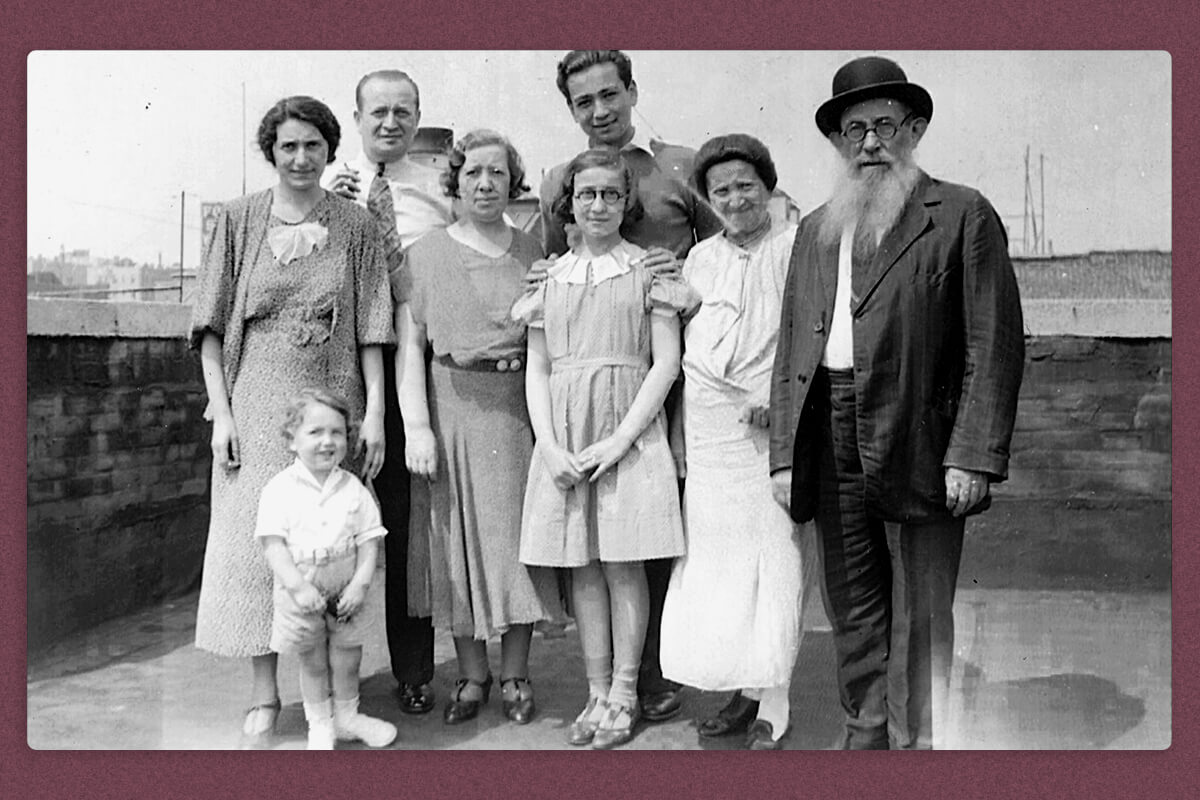 A dressed-up family of eight standing together outside, somewhere in New York City