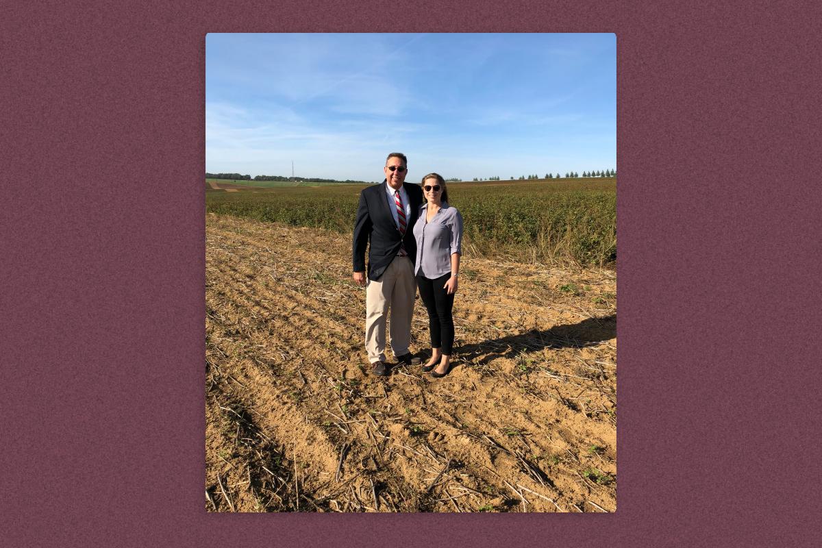 The author and her father standing in a field, where Michael Valente displayed his medal-winning heroism