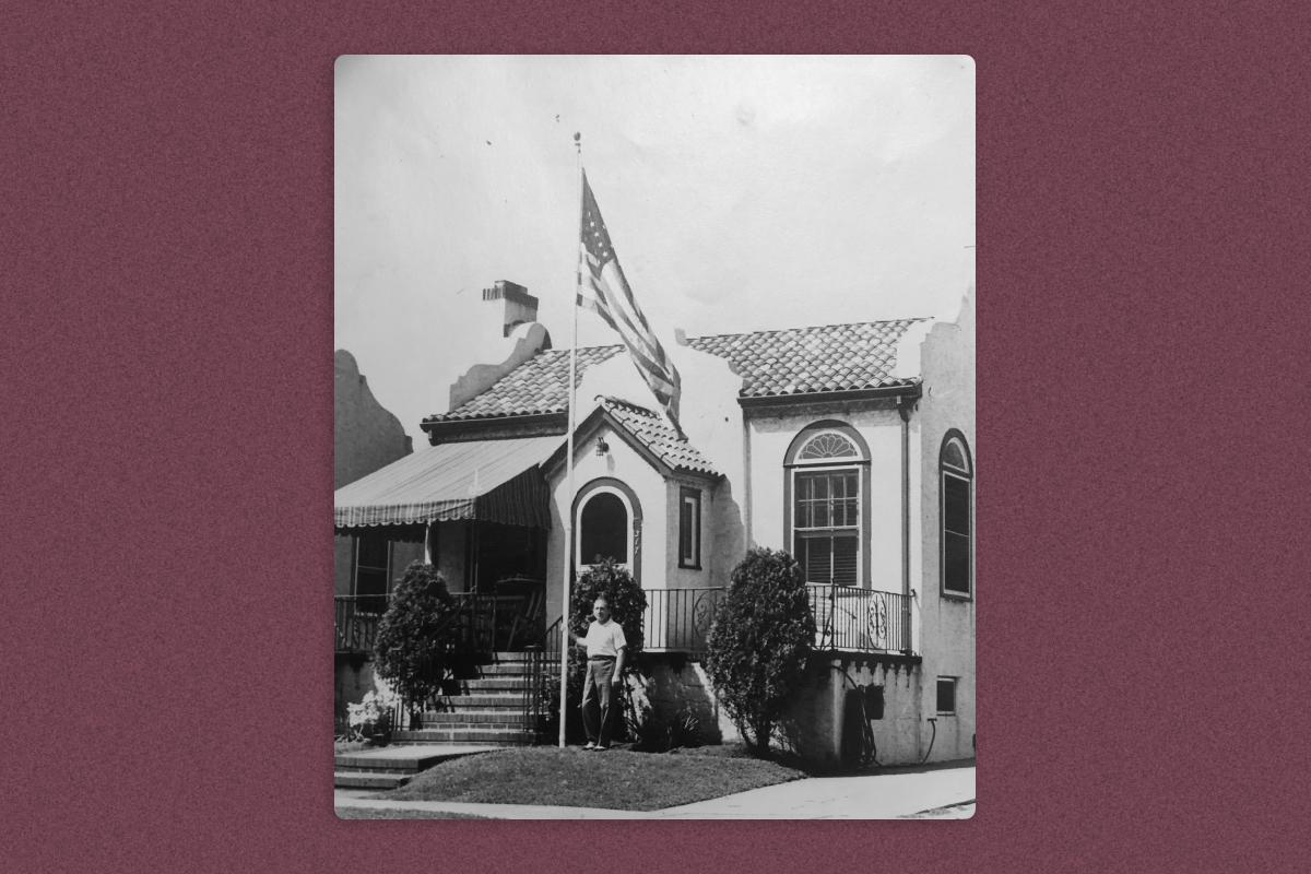 Michael Valente standing in front of his home, with an American flag proudly displayed