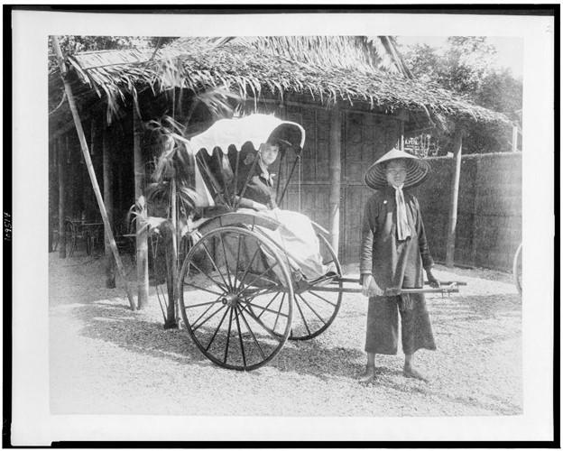 Woman seated in pousse-pousse drawn by man in Tonkin Village, Paris Exposition, 1889, Library of Congress