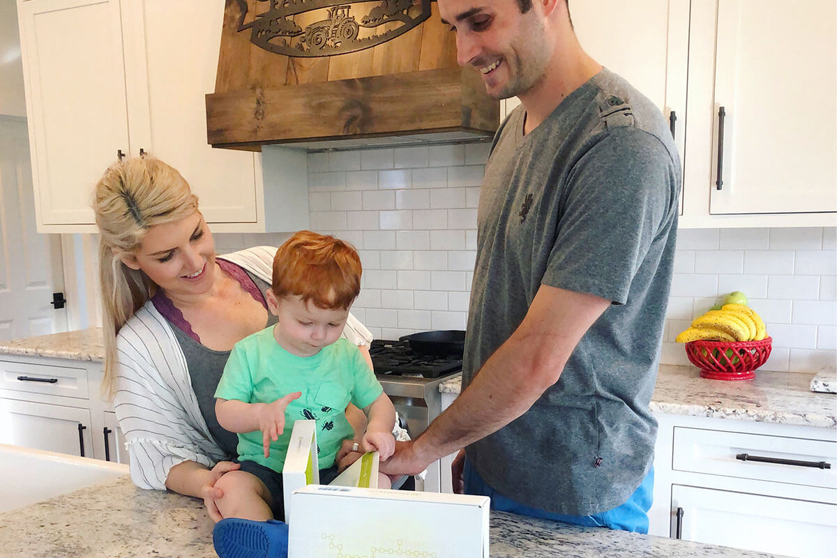 Couple with son in their kitchen.