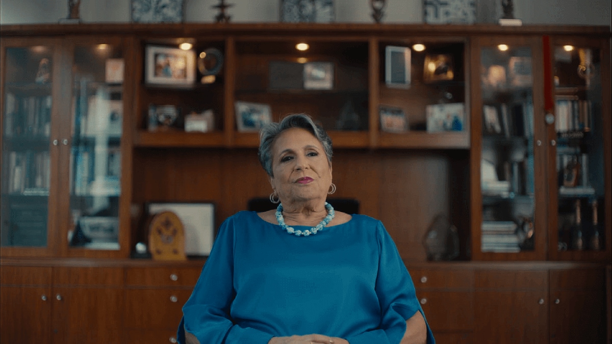 Still of Cathy Hughes being interviewed at her home.