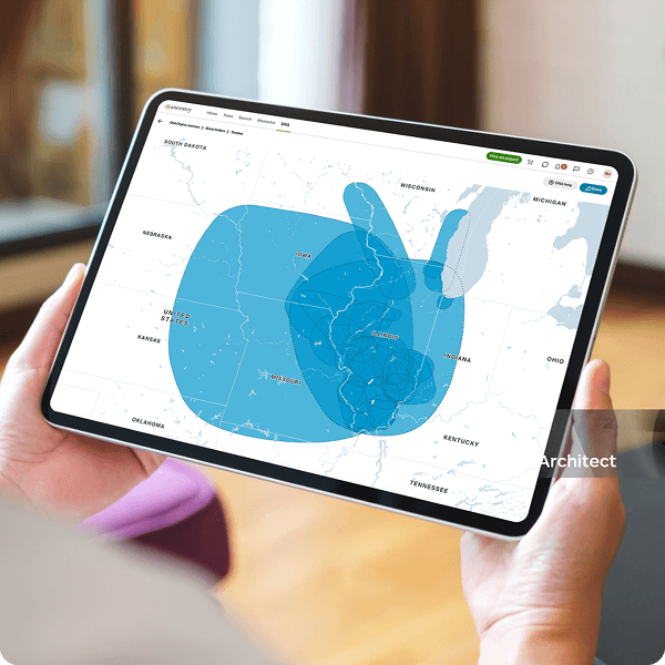 A person holding a tablet in front of them. The tablet is showing a map of DNA Journeys in the American Midwest.
