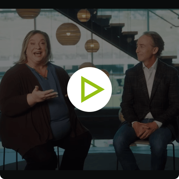 Video still frame of Crista Cowan talking to Ancestry CEO Howard Hochhauser. 